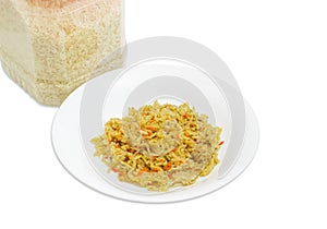 Cooked rice on dish and uncooked rice in plastic container