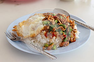 Cooked rice Kao-Pad-Kra-Prao, spicy food, chili food, or Thai rice with pork and basil, Thailand street food