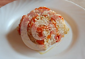 Cooked rice with a little tomato sauce photo