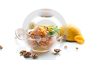 Cooked rice with pumpkin, honey and nuts. Isolated on white background