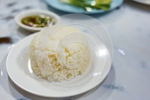 Cooked rice is ready to eat in the white dish on table dinner