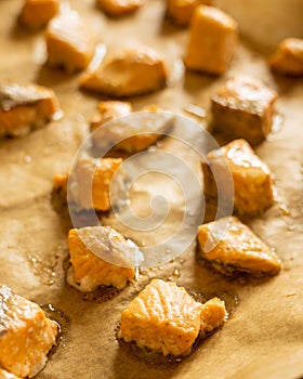 cooked salmon cubes on parchment paper