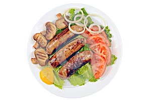 Cooked sausages with mustard, green lettuce, tomato, mushrooms and onion on a plate