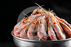 Cooked Shrimps in a metal bucket on a dark background