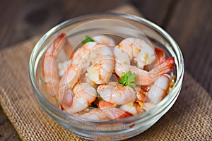 Cooked shrimps or prawns , Seafood shelfish - Shrimp delicious seasoning spices on glass bowl and wooden table background
