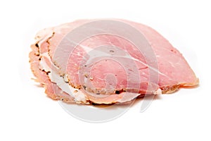 Cooked sliced ham on white