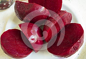 Cooked sliced peeled beetroot vegetable. Nutritional and healthy food. It`s sliced on a plate ready to be eaten or to prepare a di