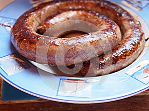 Cooked South African traditional boerewors ready to be cut and served.