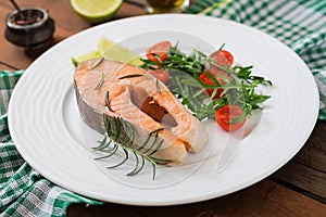 Cooked on steam salmon steak with vegetables