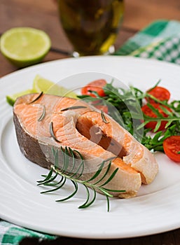 Cooked on steam salmon steak with vegetables