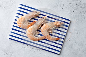 Cooked tiger prawns on striped plate