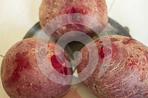 Cooked unpeeled beetroot vegetable. Nutritional and healthy food. It`s sliced on a plate ready to be eaten or to prepare a di