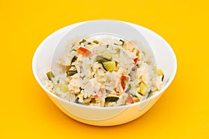 Cooked white rice mixed with colorful vegetables onion, green beans, tomato