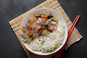 Cooked white rice mixed with fried vegetables onion, carrot, green peas, corn,  beans