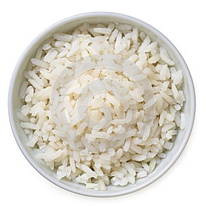 Cooked white rice in a white ceramic bowl isolated on white from above