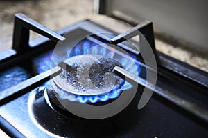 Cooker as heater. Blue flame from gas hob produce greenhouse gas emissions. Wastage of natural resources. Kitchen stove