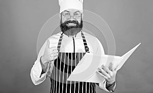 Cookery on my mind. Improve cooking skill. Book recipes. According to recipe. Man bearded chef cooking food. Culinary