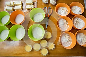 Cookery set of orange and green cups with flour, sugar, yeast, c
