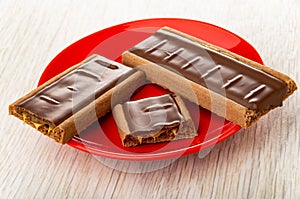 Cookie with chocolate and caramel, pieces of cookie in saucer on table