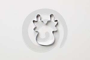 Cookie cutter in form of deer on white colored paper background. isolated. close up. mock up