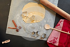 Cookie dough, cookie cutter, rolling pin, and utensils