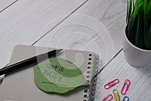 Cookie Policy write on sticky note isolated on wooden table photo