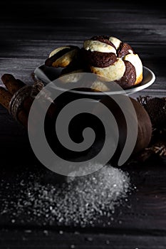 Cookies and barrel small with sugar on a dark wooden background