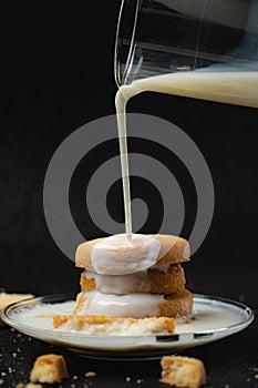 Cookies being topped with milk