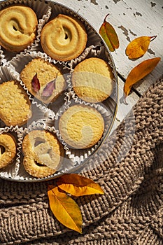 Cookies, blancket and autumn leaves. Background, biscuit
