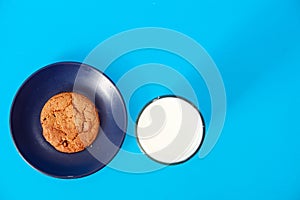 Cookies on blue background. oatmeal cookie with pieces of chocolate