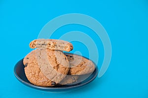 Cookies on blue background. oatmeal cookie with pieces of chocolate