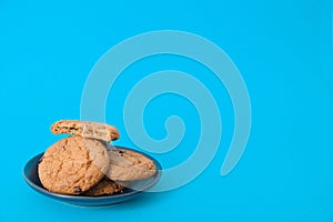 Cookies on blue background. oatmeal cookie with pieces of chocolate