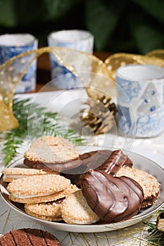 Cookies, candles and pine cone on holiday napkin