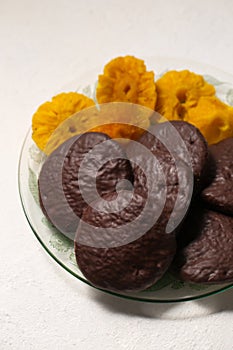 cookies in chocolate with cinnamon and candied pineapple, close-up