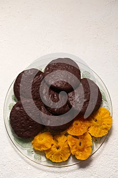 cookies in chocolate with cinnamon and candied pineapple, top view