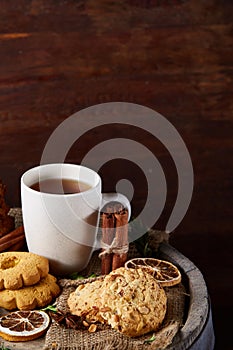 Cookies with cinnamon and two cups of tea on a burlap napkin, selective focus, close-up, top view.