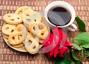 Cookies with coffee and a rose