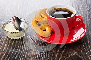 Cookies, coffee on saucer, condensed milk in bowl, spoon