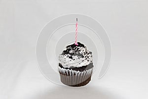 Cookies and cream cupcake with pink candle