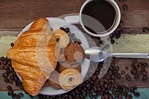 Cookies with croissant and coffee