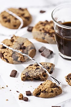 Cookies with dark chocolate chips on white plate.