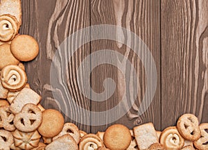 Cookies of different shapes on a wooden background