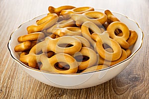 Cookies in fish shape in bowl on wooden table