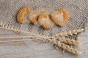 Cookies in the form of heart from whole-grain flour on a linen napkin and ears