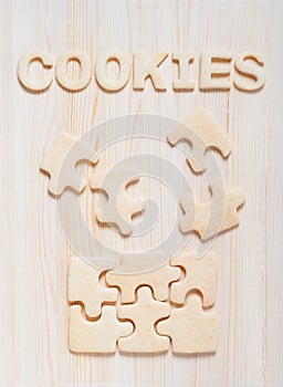 Cookies in the form of puzzles and letters on the table