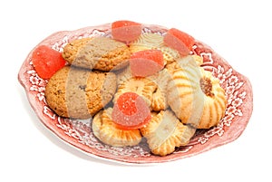 Cookies and fruit candy on glass plate