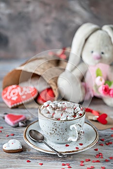 Cookies or gingerbread cookies in a gift box with a red ribbon on a wooden table. Valentine`s Day