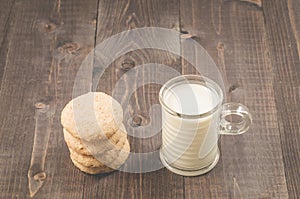 Cookies and glass of milk/cookies and glass of milk on a dark wooden background. Selective focus