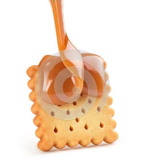 Cookies with liquid caramel on a white background