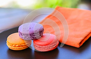 Cookies macaroons, turnovers, red, orange and purple.